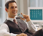 Business man using a digital dictation machine for speech recording.