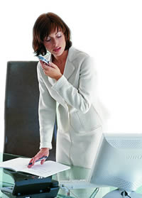 Office business woman using digital dictation at work.